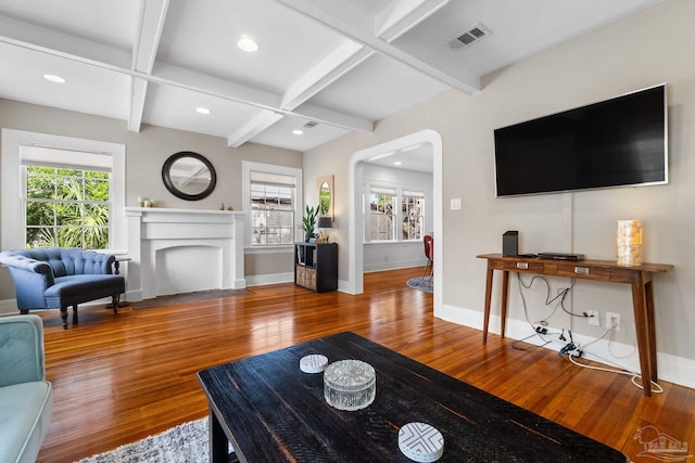 living room with hardwood / wood-style floors, beam ceiling, and coffered ceiling