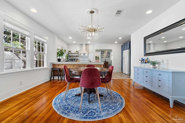 dining area with a chandelier and hardwood / wood-style flooring