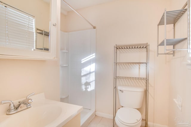 bathroom featuring a shower, tile patterned floors, toilet, and sink