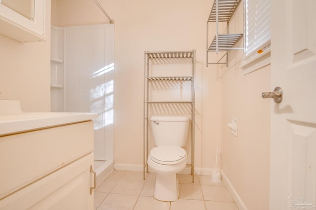 bathroom featuring tile patterned floors, a shower, vanity, and toilet