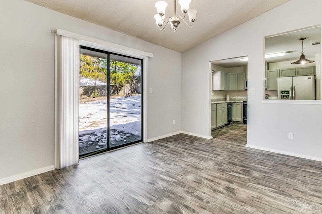 interior space featuring hardwood / wood-style flooring, lofted ceiling, and a notable chandelier