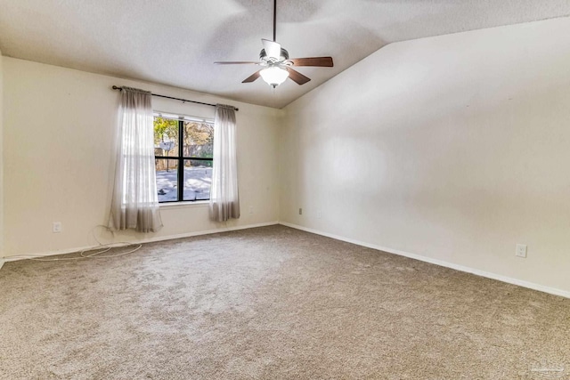 spare room featuring ceiling fan, lofted ceiling, and carpet floors