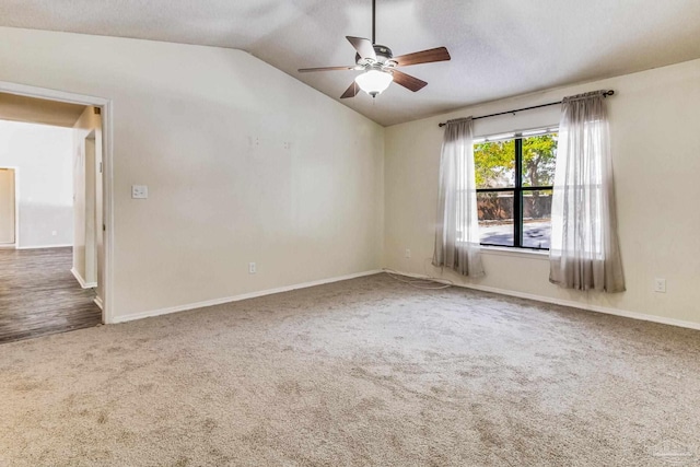 unfurnished room with vaulted ceiling, carpet floors, and ceiling fan