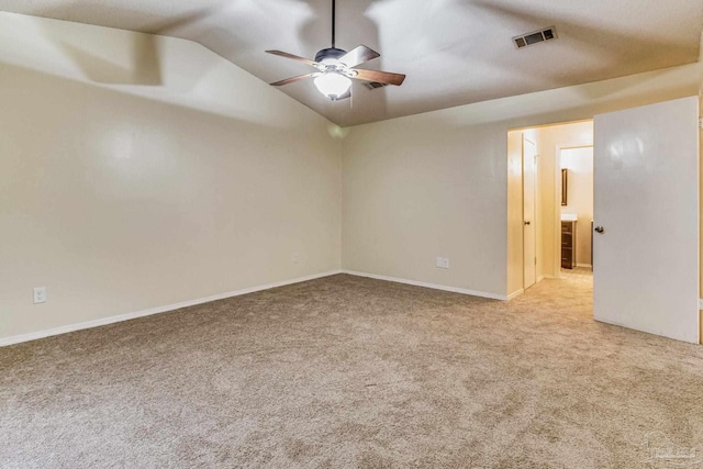 empty room featuring light carpet, vaulted ceiling, and ceiling fan