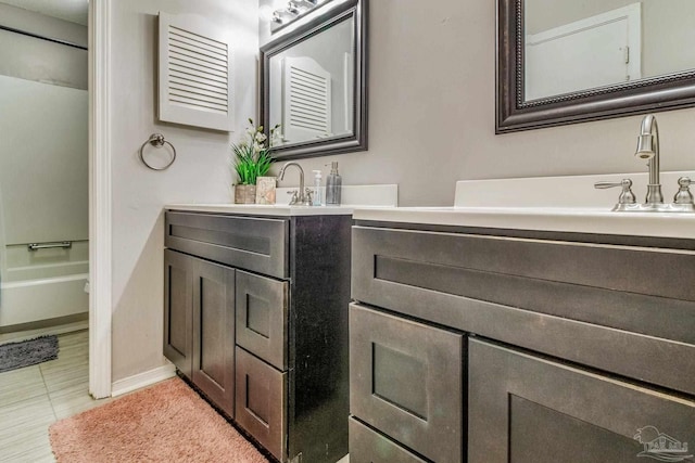 bathroom with tile patterned floors and vanity