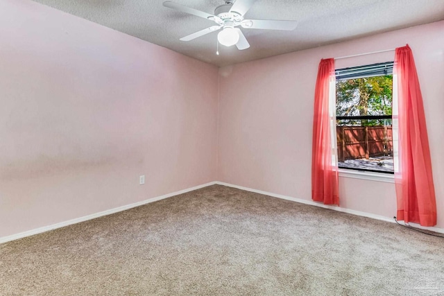 unfurnished room with ceiling fan, carpet flooring, and a textured ceiling