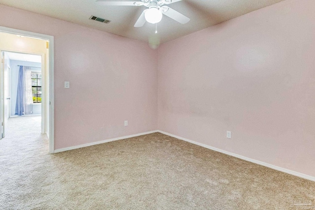 carpeted spare room with ceiling fan