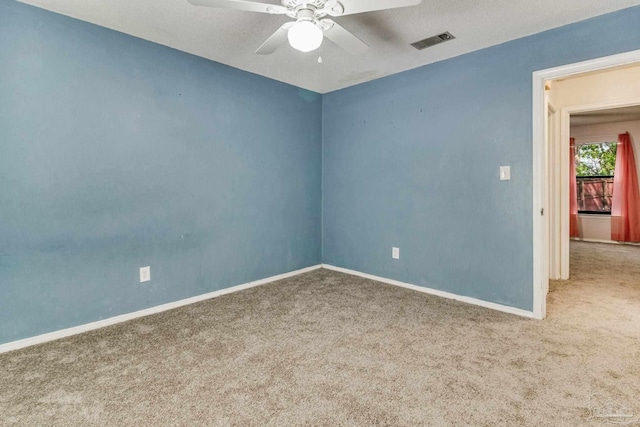 carpeted empty room featuring ceiling fan