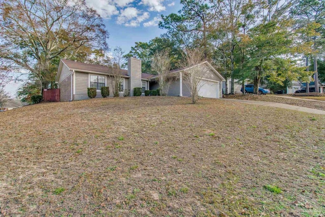 ranch-style home featuring a garage and a front lawn