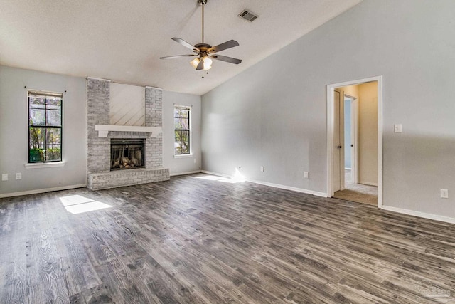 unfurnished living room featuring high vaulted ceiling, a textured ceiling, dark hardwood / wood-style flooring, ceiling fan, and a fireplace