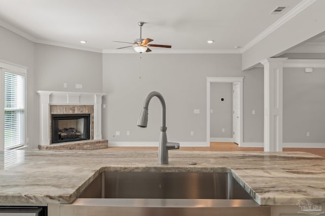 6264 Howie Way, Pace, FL 32571 - kitchen with ceiling fan, light stone countertops, crown molding, open floor plan, and a brick fireplace