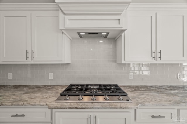 6264 Howie Way, Pace, FL 32571 - kitchen featuring stainless steel gas stovetop, white cabinetry, decorative backsplash, and light stone counters