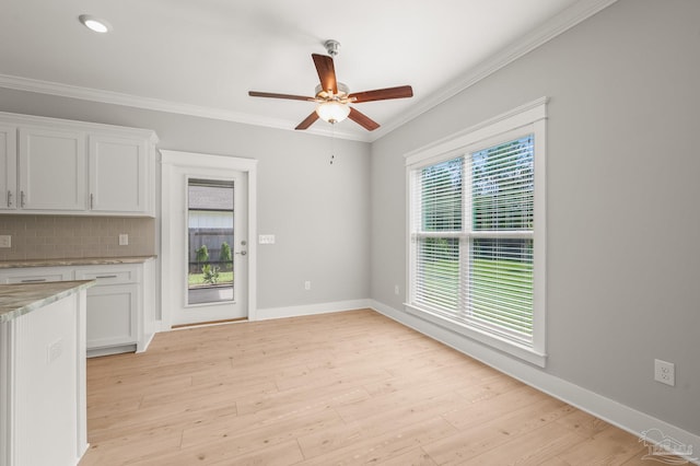 6264 Howie Way, Pace, FL 32571 - kitchen with ceiling fan, white cabinets, tasteful backsplash, crown molding, and light wood-type flooring