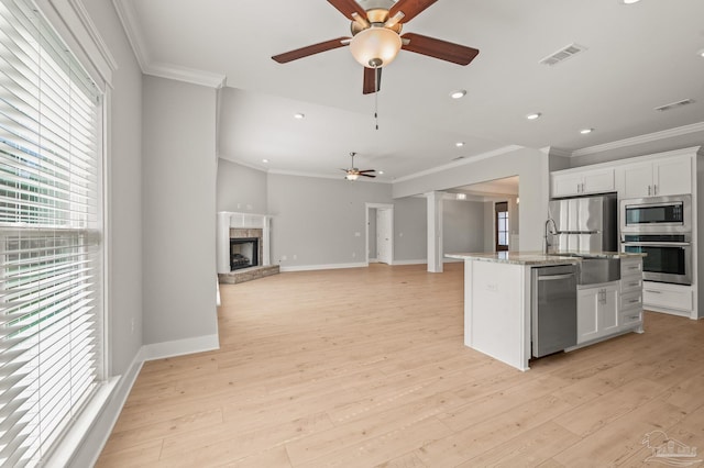 6264 Howie Way, Pace, FL 32571 - kitchen with appliances with stainless steel finishes, ceiling fan, crown molding, white cabinets, and light wood-style floors