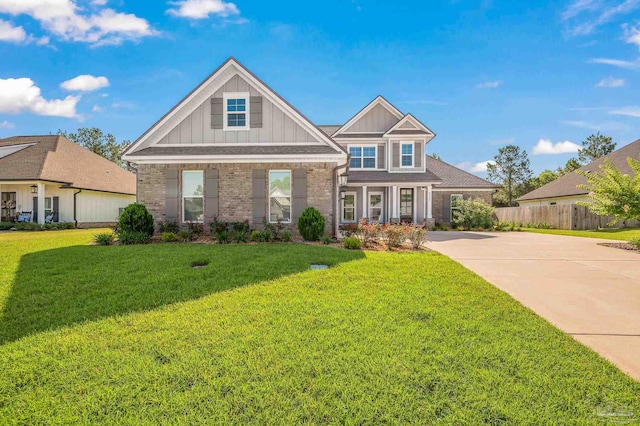 6264 Howie Way, Pace, FL 32571 - view of front facade featuring board and batten siding, brick siding, and concrete driveway