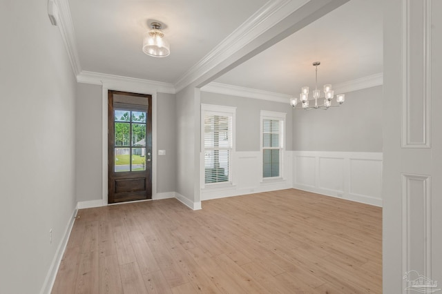 6264 Howie Way, Pace, FL 32571 - entrance foyer with light wood finished floors, a chandelier, crown molding, and a wainscoted wall