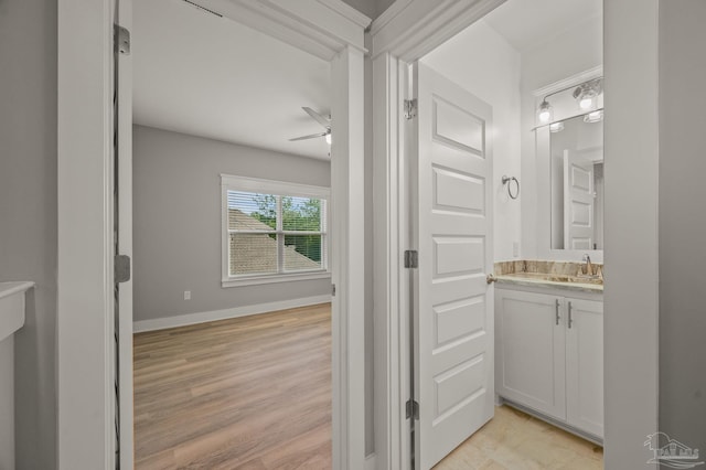 6264 Howie Way, Pace, FL 32571 - bathroom with vanity, ceiling fan, and wood finished floors