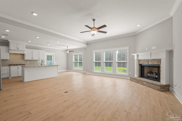 6264 Howie Way, Pace, FL 32571 - unfurnished living room with a ceiling fan, light wood-style flooring, a fireplace, recessed lighting, and crown molding
