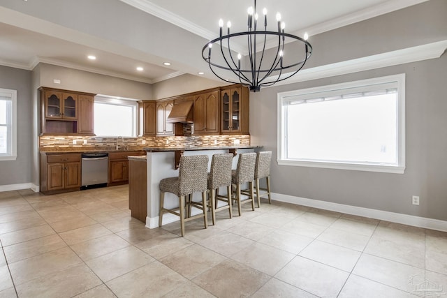 kitchen with dishwasher, brown cabinets, custom range hood, backsplash, and a breakfast bar area