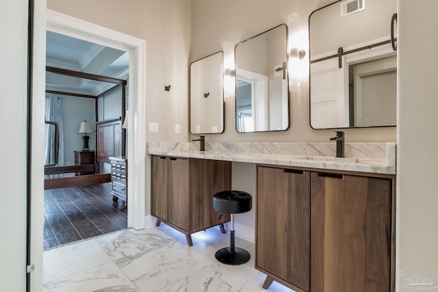 bathroom with marble finish floor, double vanity, a sink, and visible vents