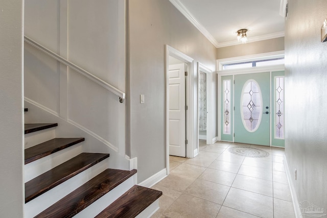 foyer entrance with crown molding, light tile patterned floors, baseboards, and stairs