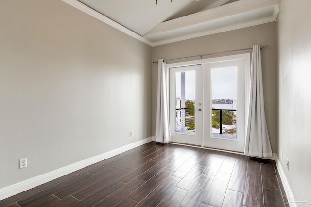 unfurnished room featuring baseboards, vaulted ceiling, french doors, crown molding, and dark wood finished floors