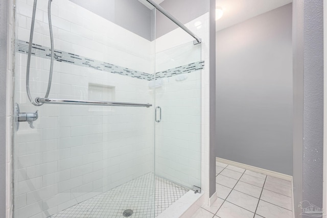 2205 Valle Escondido Dr, Pensacola, FL 32526 - bathroom with a stall shower, tile patterned floors, and baseboards