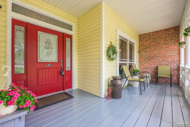 2205 Valle Escondido Dr, Pensacola, FL 32526 - view of exterior entry featuring covered porch and brick siding