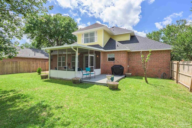 2205 Valle Escondido Dr, Pensacola, FL 32526 - rear view of property with a sunroom, a shingled roof, a patio area, and brick siding
