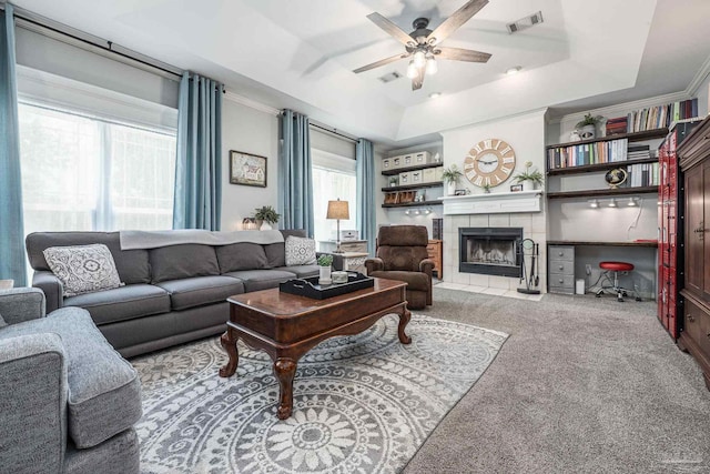 2205 Valle Escondido Dr, Pensacola, FL 32526 - carpeted living area featuring a raised ceiling, ceiling fan, ornamental molding, and a fireplace