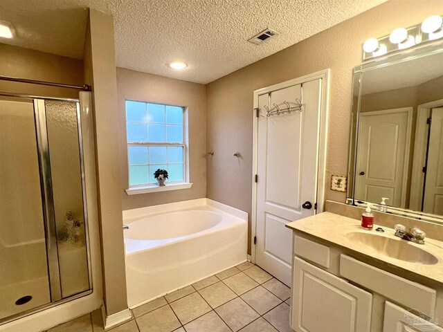 full bathroom with a stall shower, tile patterned floors, visible vents, and a bath