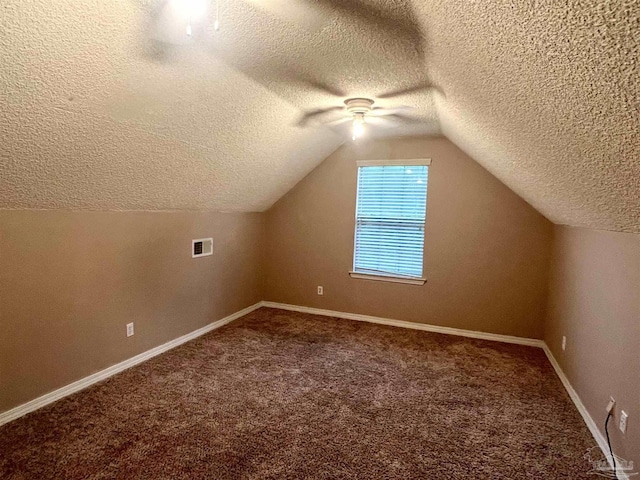 bonus room with vaulted ceiling, carpet flooring, baseboards, visible vents, and ceiling fan