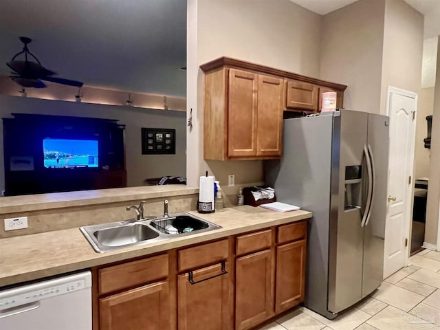 kitchen featuring stainless steel refrigerator with ice dispenser, a sink, ceiling fan, dishwasher, and brown cabinets