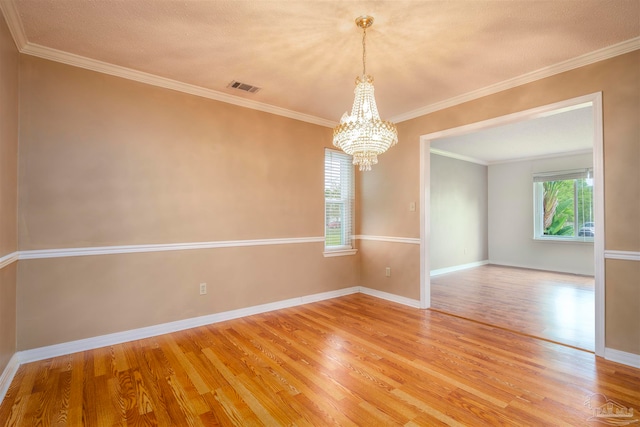 spare room with ornamental molding and hardwood / wood-style floors