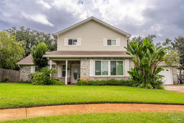 view of property with a garage and a front lawn