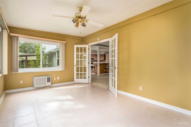 empty room featuring ceiling fan, french doors, and a wall mounted air conditioner