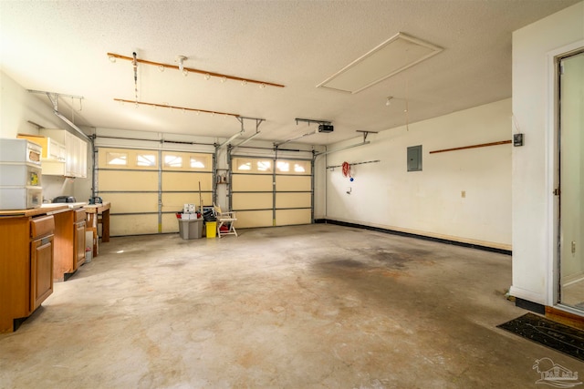 garage with a garage door opener and electric panel