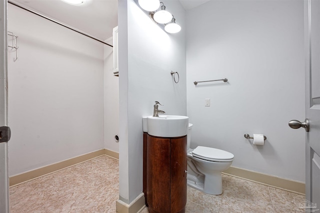 bathroom featuring tile patterned flooring, toilet, and vanity