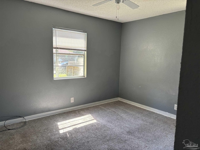 unfurnished room featuring baseboards, carpet floors, and a textured ceiling