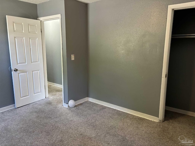 unfurnished bedroom featuring carpet and baseboards