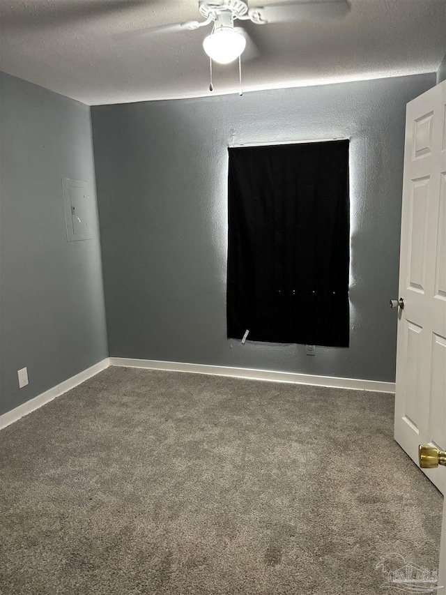 empty room featuring baseboards, a textured ceiling, and carpet flooring