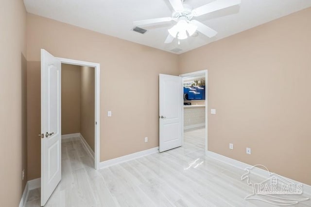 2172 Hadleigh Hills Ct, Navarre, FL 32566 - unfurnished bedroom featuring light wood finished floors and a ceiling fan