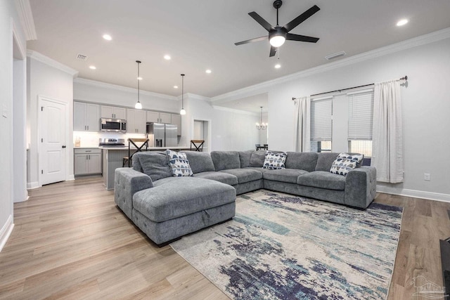 3248 Mountain Laurel Trl, Cantonment, FL 32533 - living room featuring light wood-type flooring, a chandelier, ceiling fan, recessed lighting, and crown molding