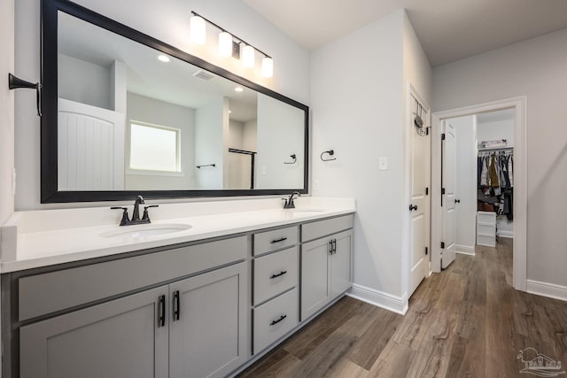 3248 Mountain Laurel Trl, Cantonment, FL 32533 - full bath featuring wood finished floors, double vanity, a spacious closet, and recessed lighting