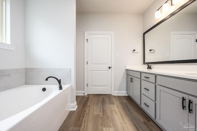 3248 Mountain Laurel Trl, Cantonment, FL 32533 - full bathroom featuring double vanity, wood finished floors, and a garden tub