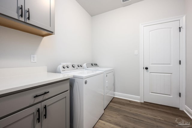3248 Mountain Laurel Trl, Cantonment, FL 32533 - washroom with washer and clothes dryer, cabinet space, and wood finished floors