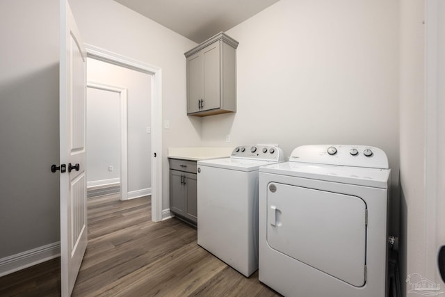 3248 Mountain Laurel Trl, Cantonment, FL 32533 - laundry room with separate washer and dryer, cabinet space, and wood finished floors
