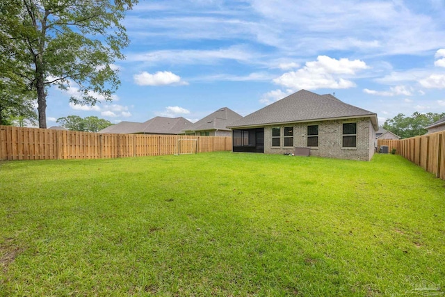 3248 Mountain Laurel Trl, Cantonment, FL 32533 - back of property with a fenced backyard, a sunroom, brick siding, and a shingled roof