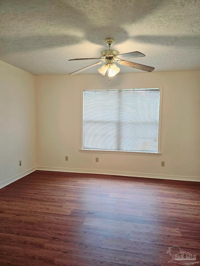 spare room with plenty of natural light and a textured ceiling