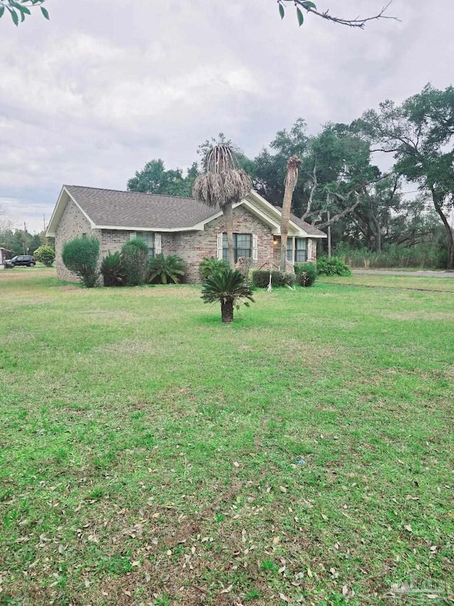 view of property exterior with a lawn